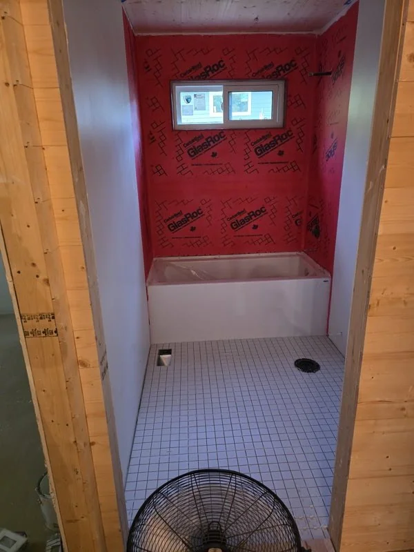 Bathroom rough-in with waterproofing membrane and a new tub installed