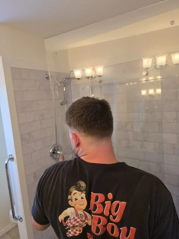 Big Boy Enterprises tradesperson finishing a marble tile shower