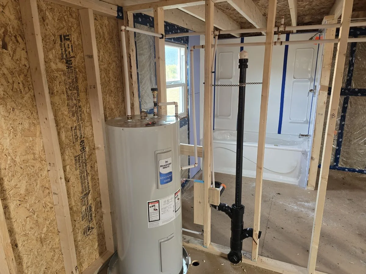 New hot water tank and tub installed during a bathroom build in the Shuswap