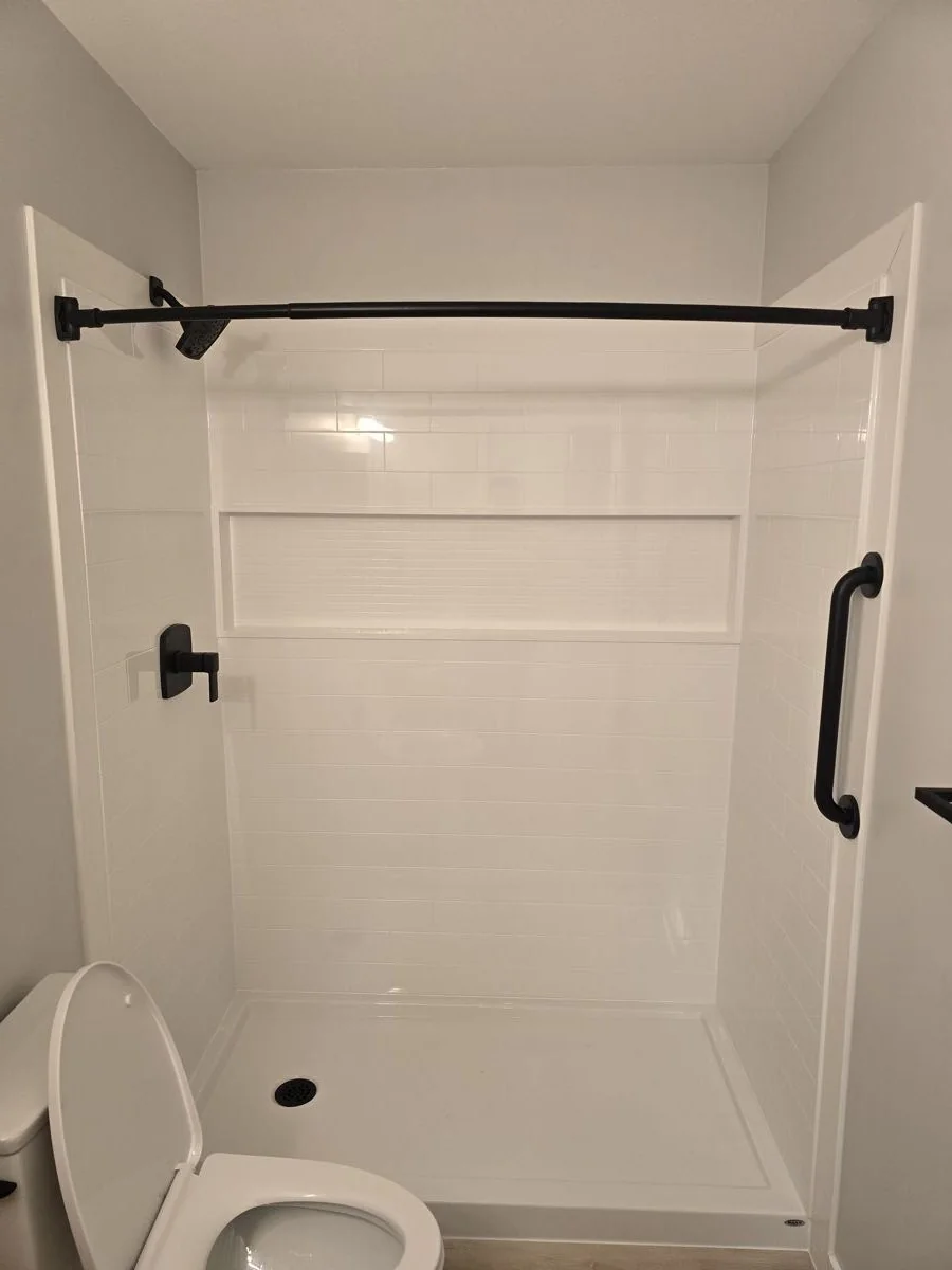 Tub and shower surround with black fixtures