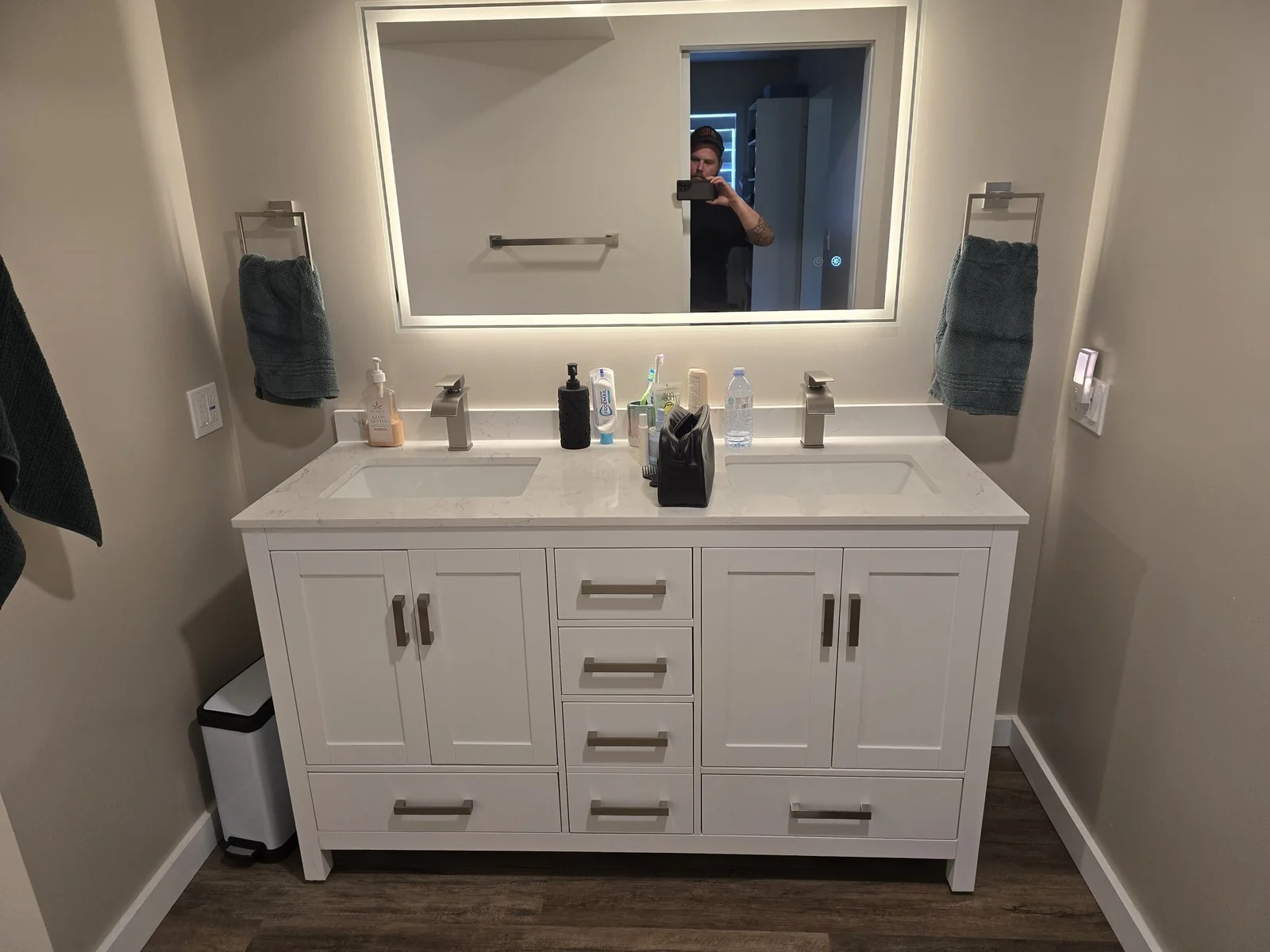 Finished bathroom renovation with a double vanity and framed mirrors