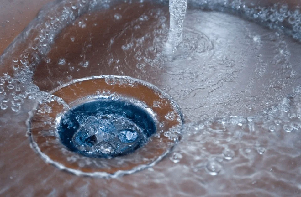 Water draining freely through a clear sink drain