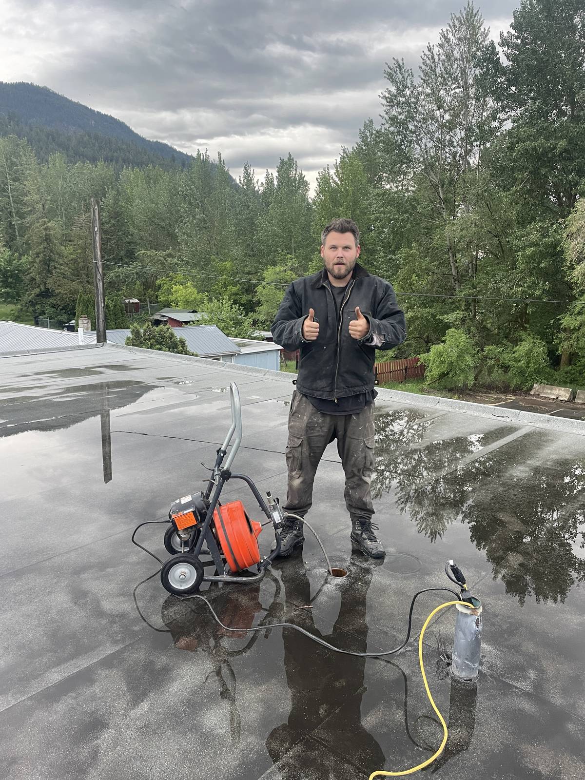 Jeff of Big Boy Enterprises with a drain cleaning machine on a job in the Shuswap