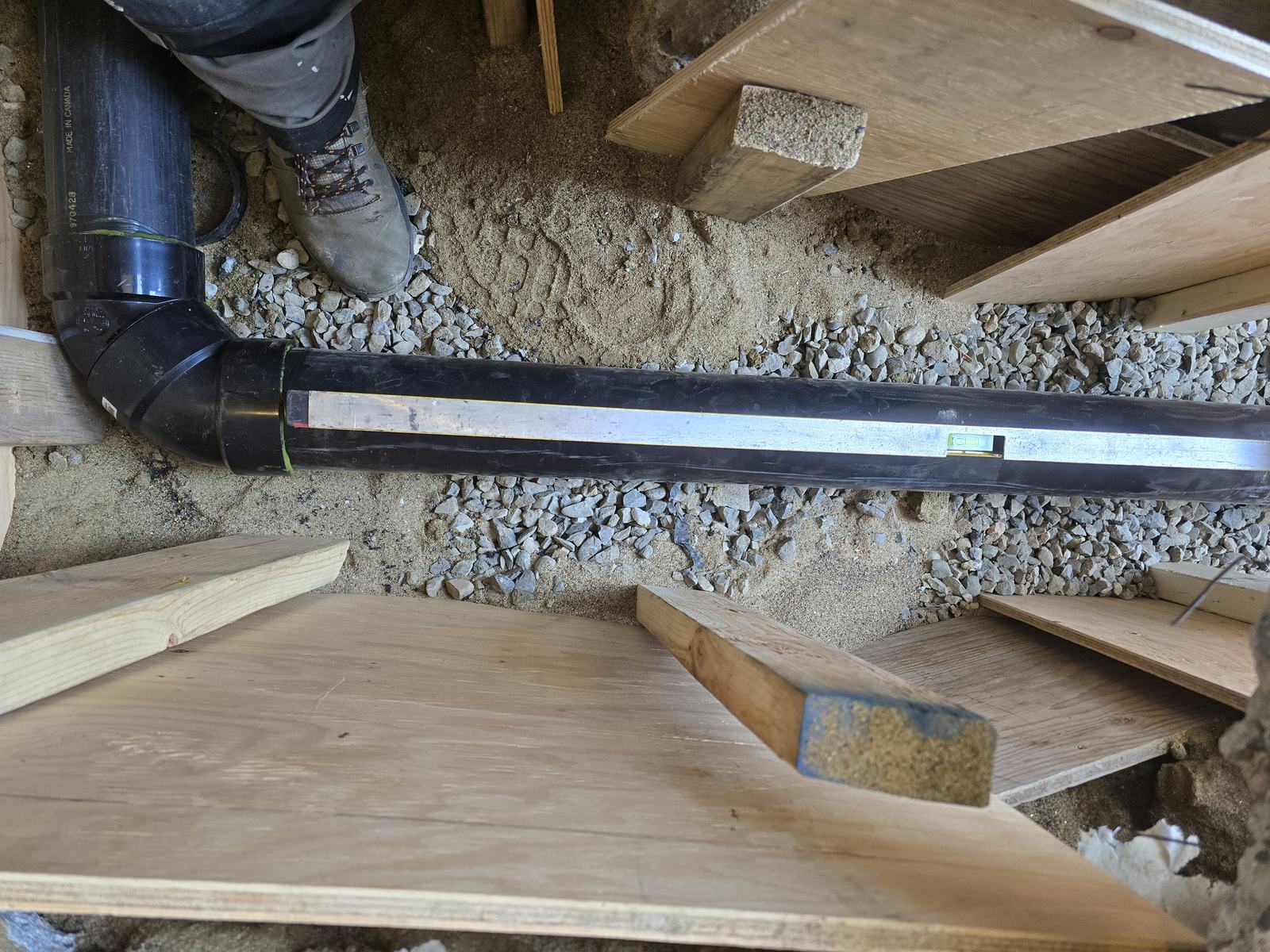 ABS drain and vent piping run through a framed floor system