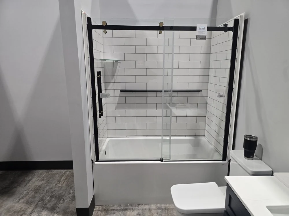 Renovated bathroom with subway tile tub surround and black fixtures